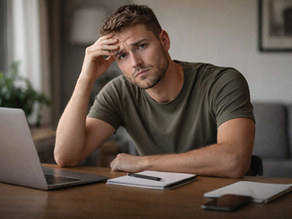 Een jonge belegger kijkt met paniek op van zijn laptop 