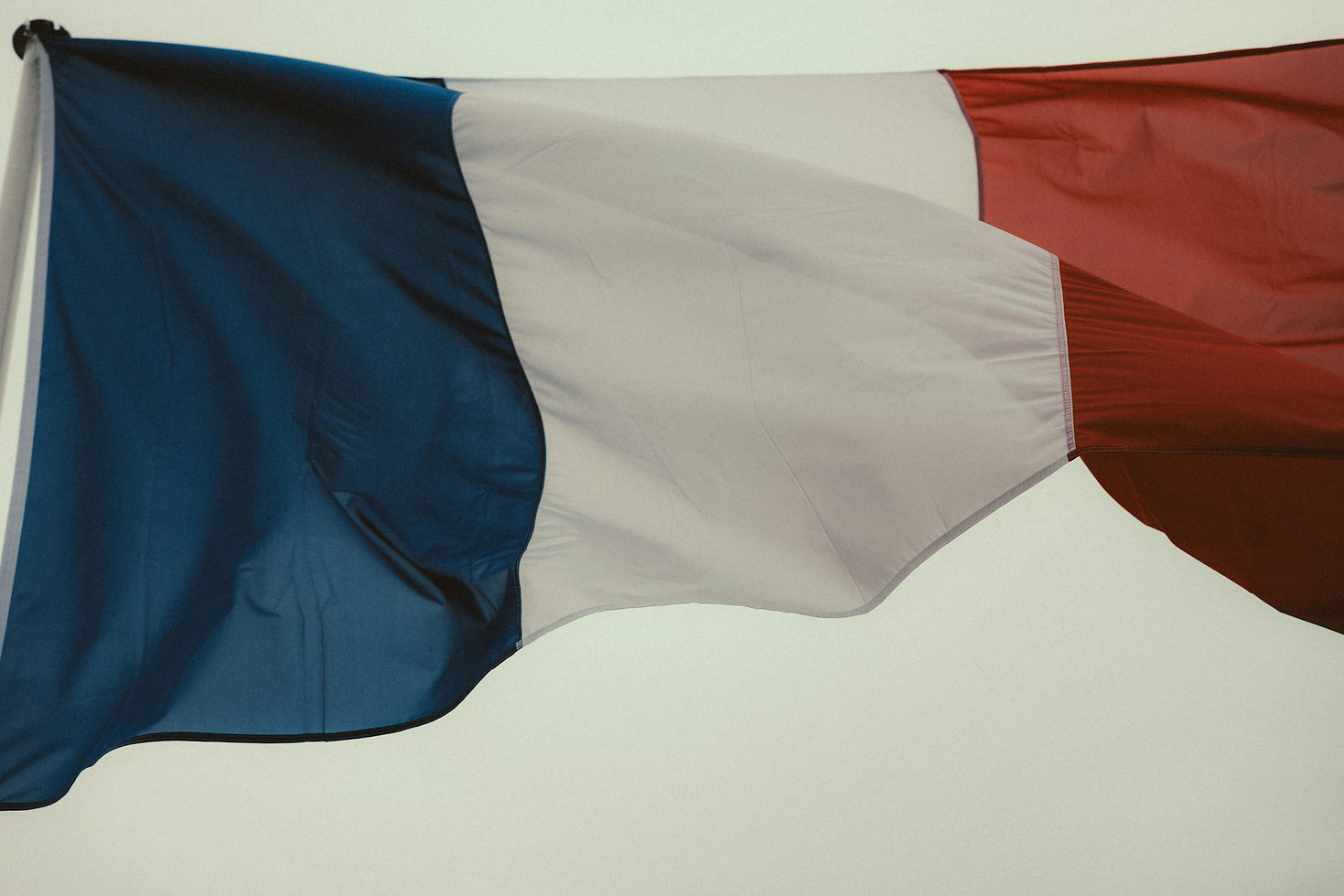 De Franse blauw-wit-rode vlag wappert aan een vlaggenmast.